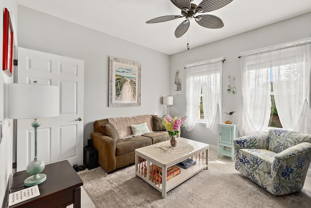 carpeted living room with ceiling fan