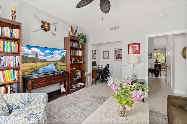 tiled living room with ceiling fan