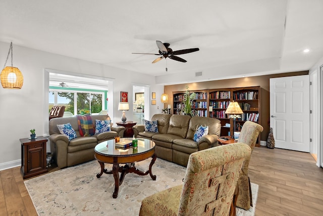 living room featuring ceiling fan and light wood-type flooring