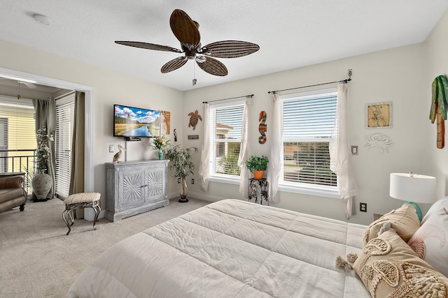 carpeted bedroom with ceiling fan and a textured ceiling