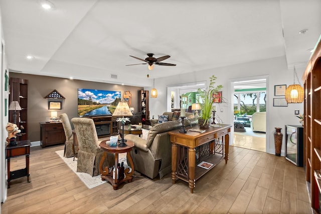 living room with ceiling fan and light hardwood / wood-style floors