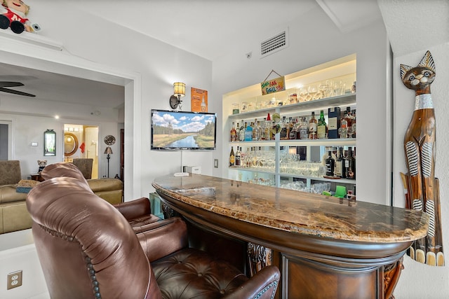 bar with ceiling fan and ornamental molding