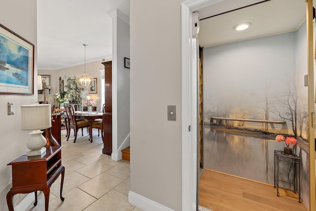1602 Windjammer Ln, Saint Augustine, FL 32084 - hallway with a chandelier, ornamental molding, and light tile patterned floors