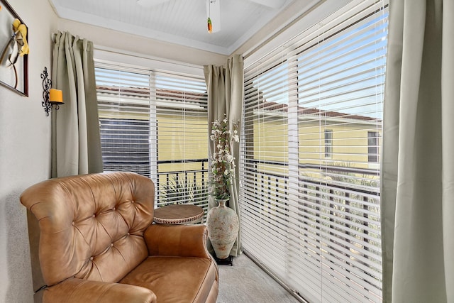 sitting room featuring ceiling fan and crown molding