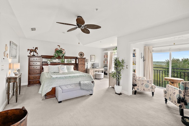 bedroom featuring light carpet, access to outside, and ceiling fan