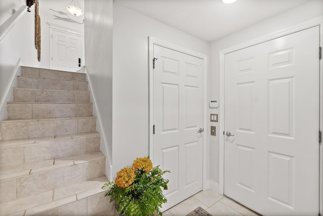 foyer entrance featuring light tile patterned floors