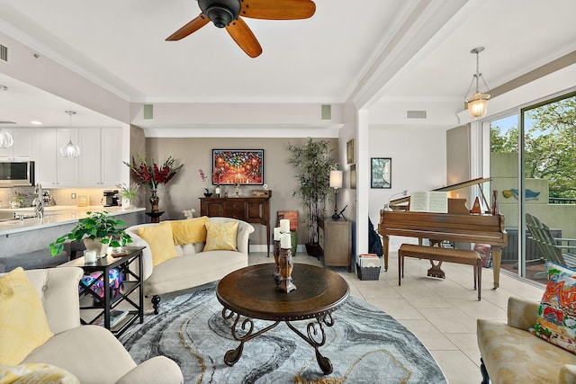 tiled living room featuring ceiling fan and crown molding