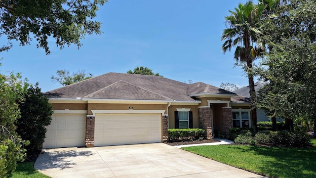 326 Gianna Way, Saint Augustine, FL 32086 - view of front of property featuring stone siding, stucco siding, driveway, and an attached garage
