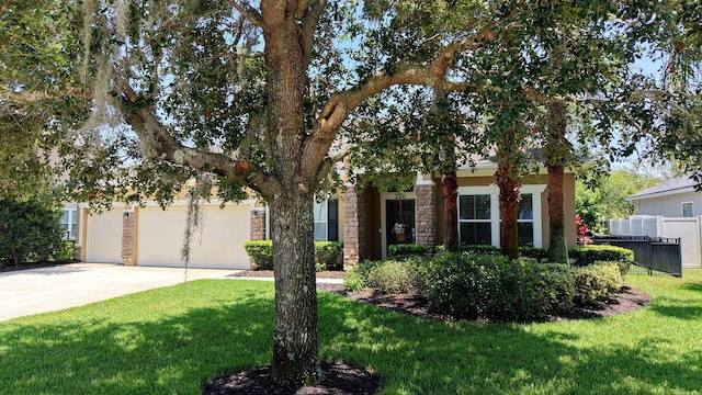 326 Gianna Way, Saint Augustine, FL 32086 - view of property hidden behind natural elements featuring driveway, an attached garage, and stone siding