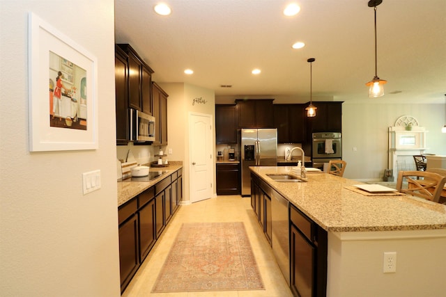 326 Gianna Way, Saint Augustine, FL 32086 - kitchen with stainless steel appliances, a kitchen island with sink, recessed lighting, decorative light fixtures, and light stone counters