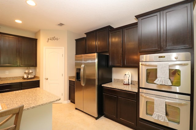326 Gianna Way, Saint Augustine, FL 32086 - kitchen featuring stainless steel appliances, recessed lighting, light stone counters, and dark brown cabinets