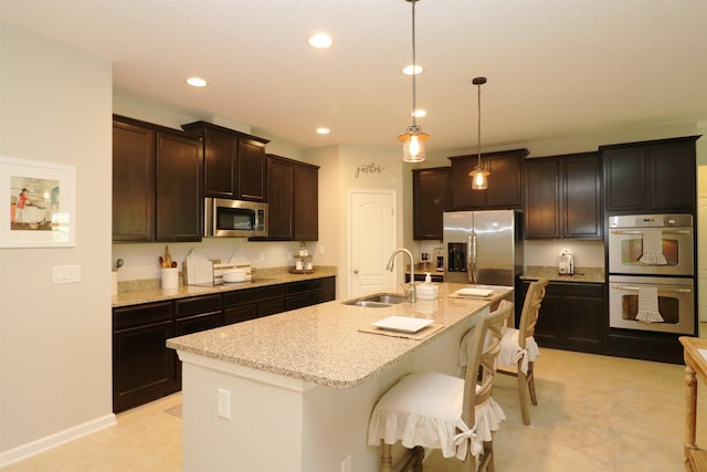 326 Gianna Way, Saint Augustine, FL 32086 - kitchen with stainless steel appliances, recessed lighting, light stone counters, a kitchen bar, and an island with sink