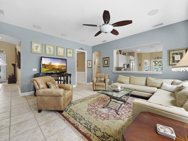 304 1st St, Saint Augustine, FL 32084 - living area featuring arched walkways, ceiling fan, and light tile patterned floors