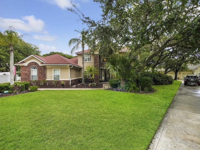 304 1st St, Saint Augustine, FL 32084 - view of front facade with a front lawn and stucco siding