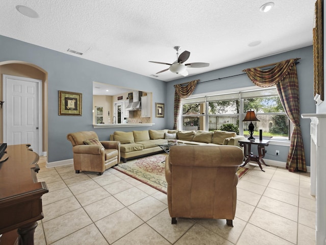304 1st St, Saint Augustine, FL 32084 - living room featuring light tile patterned floors, a ceiling fan, a textured ceiling, and healthy amount of natural light