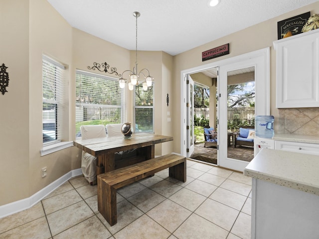 304 1st St, Saint Augustine, FL 32084 - dining room featuring light tile patterned floors and a chandelier