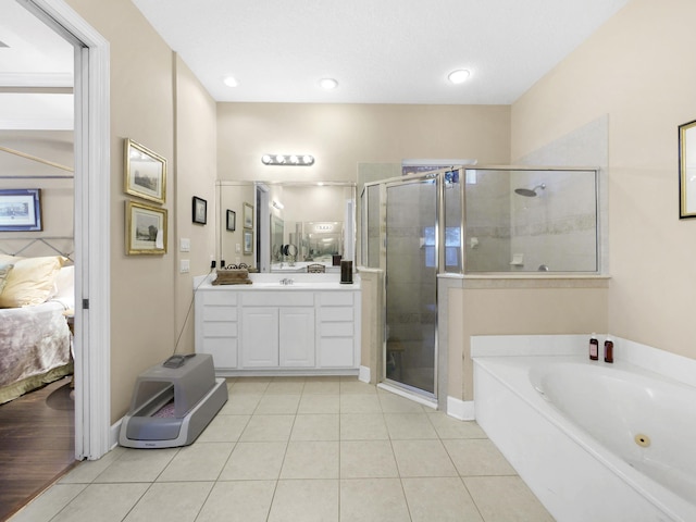 304 1st St, Saint Augustine, FL 32084 - ensuite bathroom featuring vanity, a garden tub, a shower stall, tile patterned floors, and recessed lighting