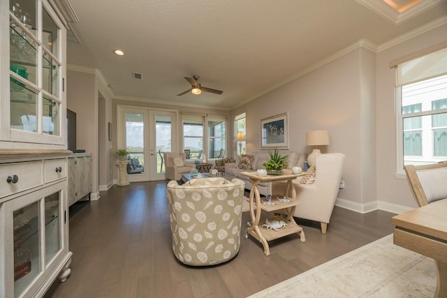 living room featuring french doors, ceiling fan, crown molding, and dark hardwood / wood-style flooring