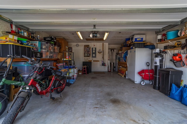 142 Patriot Ln, Elkton, FL 32033 - garage with a garage door opener and freestanding refrigerator