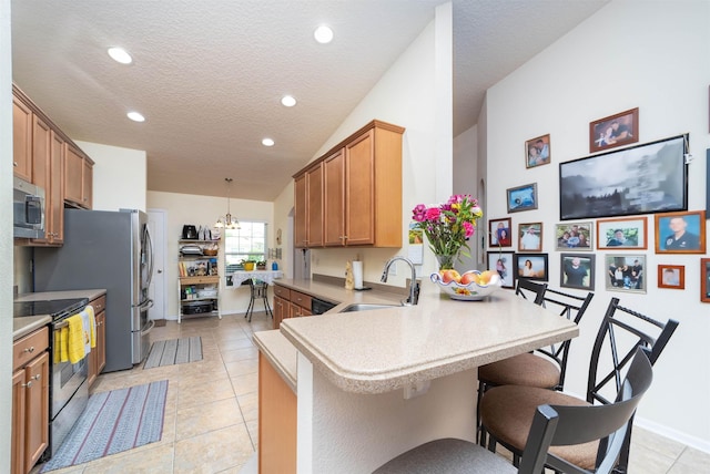 142 Patriot Ln, Elkton, FL 32033 - kitchen featuring a sink, appliances with stainless steel finishes, a peninsula, light countertops, and recessed lighting