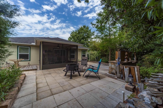 142 Patriot Ln, Elkton, FL 32033 - view of patio with a sunroom, an outdoor fire pit, and a ceiling fan
