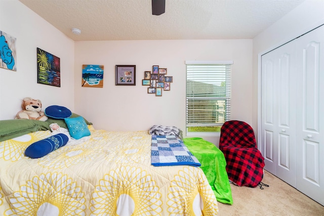 142 Patriot Ln, Elkton, FL 32033 - carpeted bedroom with a closet, a ceiling fan, and a textured ceiling