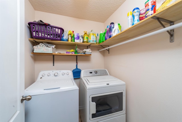 142 Patriot Ln, Elkton, FL 32033 - clothes washing area with washing machine and clothes dryer and a textured ceiling