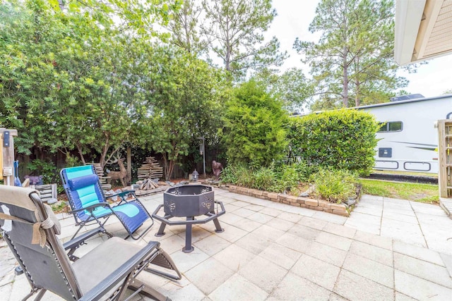 142 Patriot Ln, Elkton, FL 32033 - view of patio with an outdoor fire pit and fence