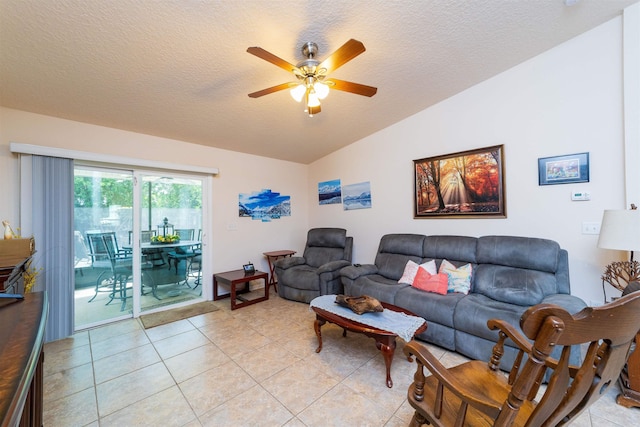 142 Patriot Ln, Elkton, FL 32033 - living area featuring vaulted ceiling, ceiling fan, light tile patterned floors, and a textured ceiling