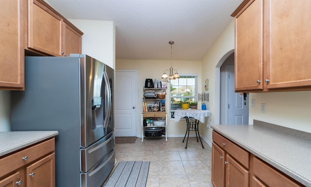 142 Patriot Ln, Elkton, FL 32033 - kitchen featuring stainless steel refrigerator with ice dispenser, arched walkways, light countertops, a chandelier, and pendant lighting