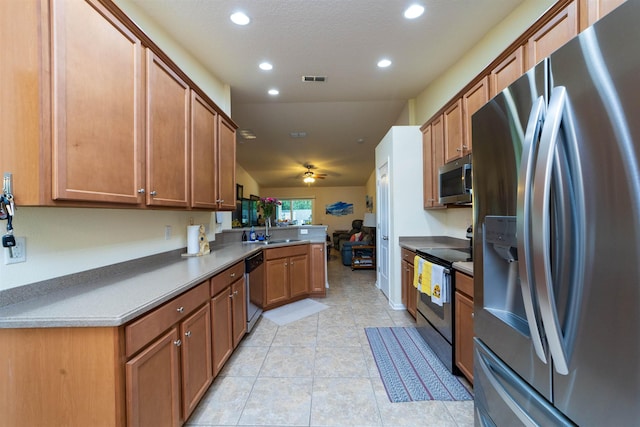 142 Patriot Ln, Elkton, FL 32033 - kitchen with appliances with stainless steel finishes, a sink, a peninsula, recessed lighting, and brown cabinets