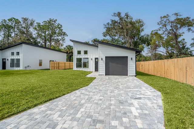 view of front facade with a front yard and a garage