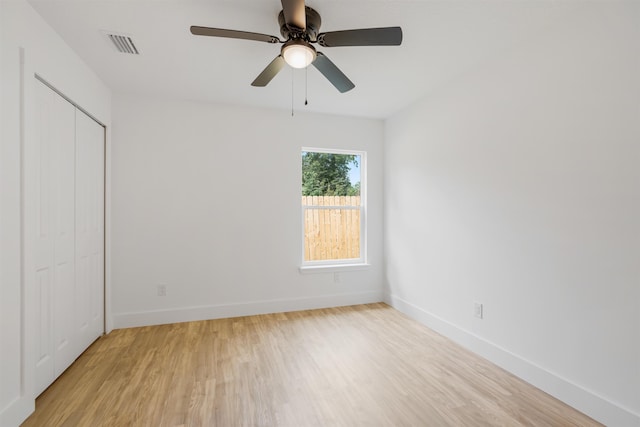 unfurnished bedroom with ceiling fan, a closet, and light hardwood / wood-style flooring