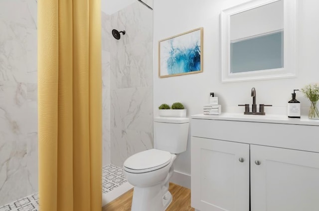 bathroom featuring a shower with shower curtain, vanity, toilet, and hardwood / wood-style flooring