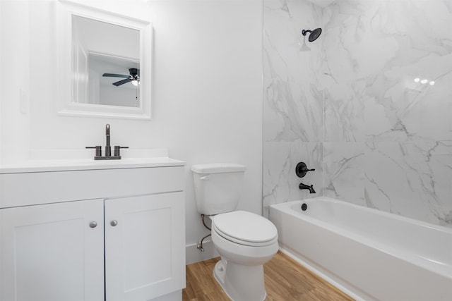 full bathroom featuring vanity, ceiling fan, wood-type flooring, toilet, and tiled shower / bath