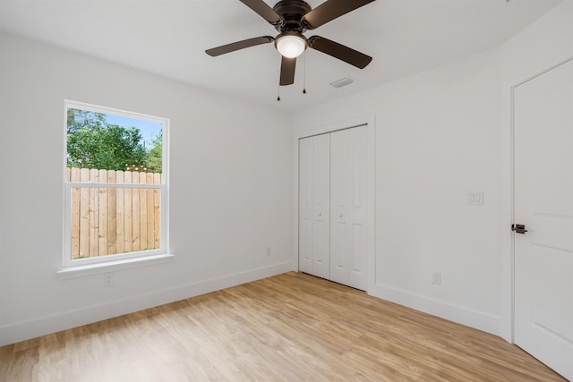 unfurnished bedroom with ceiling fan, a closet, and light hardwood / wood-style flooring