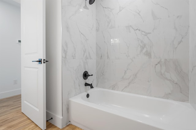 bathroom featuring hardwood / wood-style floors and tiled shower / bath