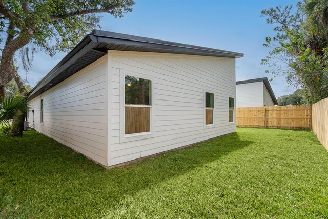 view of home's exterior with a yard