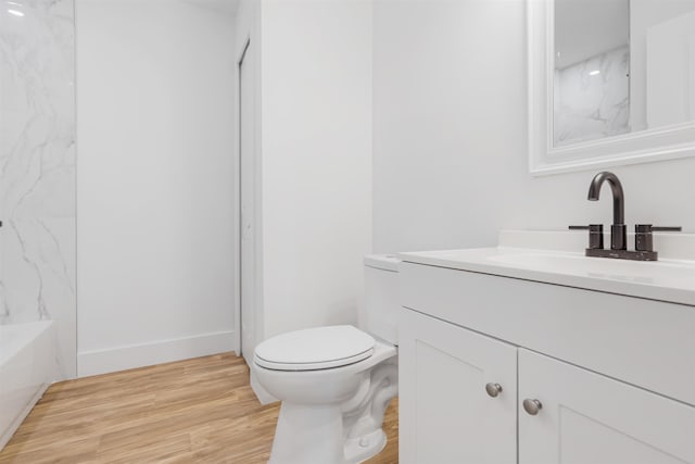 full bathroom featuring wood-type flooring, vanity, toilet, and tiled shower / bath