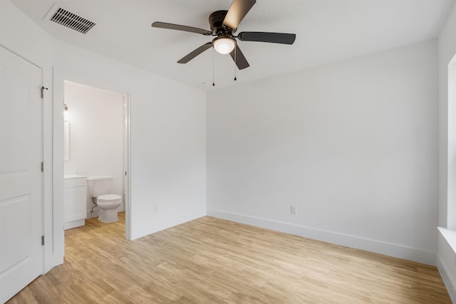 unfurnished bedroom featuring connected bathroom, ceiling fan, and light hardwood / wood-style flooring