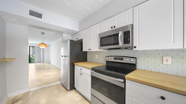 5811 Atlantic Blvd Unit 57, Jacksonville, FL 32207 - kitchen featuring stainless steel appliances, backsplash, finished concrete flooring, and white cabinets