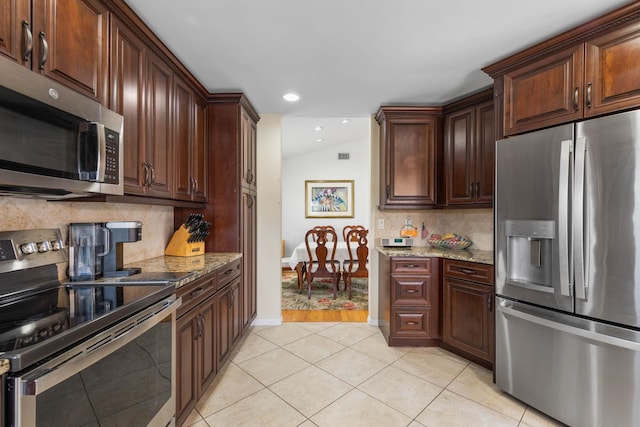 19 San Rafael Ct, Palm Coast, FL 32137 - kitchen featuring appliances with stainless steel finishes, light tile patterned floors, light stone countertops, tasteful backsplash, and recessed lighting