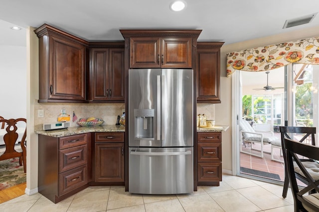 19 San Rafael Ct, Palm Coast, FL 32137 - kitchen with stainless steel fridge, tasteful backsplash, light stone countertops, light tile patterned floors, and recessed lighting