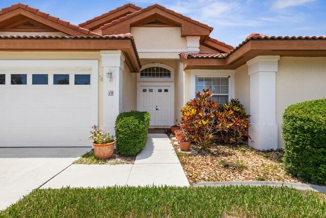 19 San Rafael Ct, Palm Coast, FL 32137 - mediterranean / spanish-style home featuring an attached garage, stucco siding, and a tile roof