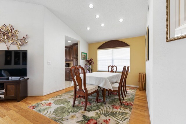 19 San Rafael Ct, Palm Coast, FL 32137 - dining room featuring recessed lighting, light wood finished floors, high vaulted ceiling, and radiator