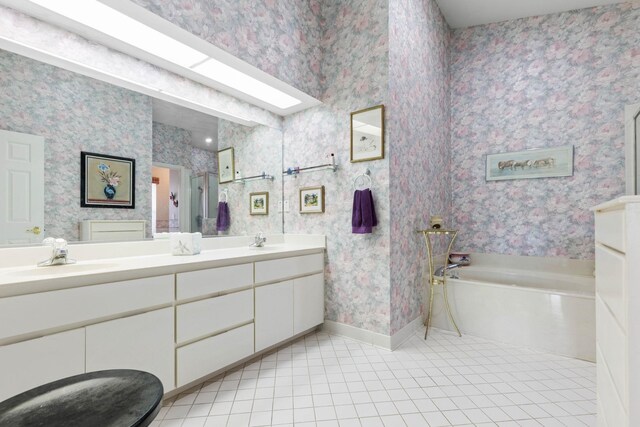 19 San Rafael Ct, Palm Coast, FL 32137 - full bathroom featuring tile patterned floors, double vanity, a garden tub, baseboards, and wallpapered walls