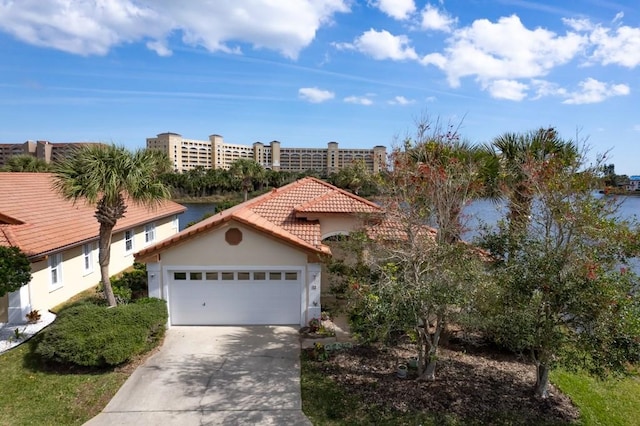 view of front of house featuring an attached garage, driveway, a tiled roof, and stucco siding