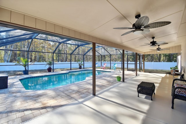 view of swimming pool with a mountain view, glass enclosure, ceiling fan, and a patio area