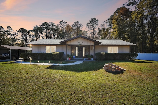 single story home featuring a yard and a carport