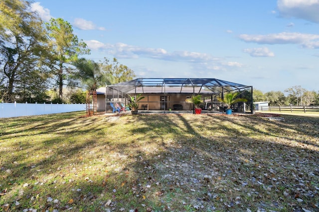 view of yard featuring glass enclosure